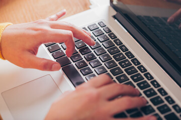 Close up of woman's hands using computer keyboard. Enterprising woman, use of technology