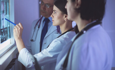 Fototapeta premium Group of doctors examining x-rays in a hospital