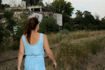 Woman walking in an abandoned railway station © belizar