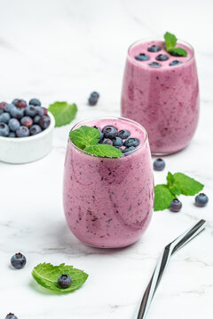 Bilberry yogurt cocktail on a light background. Natural detox. vertical image. top view. place for text