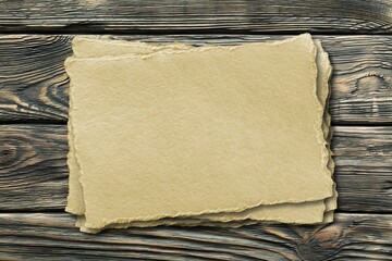Inspirational handmade paper against rustic weathered wood, storytelling and narration concept.