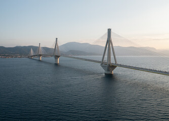 Fototapeta premium Aerial view of cable bridge of Rio - Antirio during sunrise, 