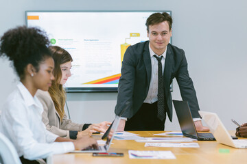 Diverse colleagues gather in brainstorm discuss statistics together. Group of people colleagues gather doing Brainstorming business plan together. Team Brainstorm Working Concept.	