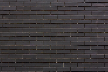 Texture black brick wall pattern for background. black brick wall texture background material of industry building construction. the wall is made of black brick.