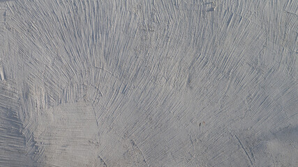 Whitewash texture on the wall with decorative brush stripes, decorative plaster of a white wall