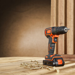 Drill on wooden desk and workshop interior. Free space for your decoration. 