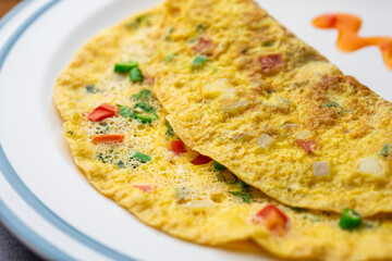Indian Spiced Masala Omelet filled with fresh vegetable, healthy meal - obrazy, fototapety, plakaty