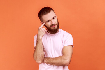 Portrait of bearded man contemplating leaning head on hand, pondering difficult question, trying to...