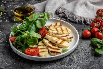 halloumi cheese with mint. alad with grilled halloumi cheese, tomatoes, capers, lettuce and arugula, Cyprus squeaky cheese. top view