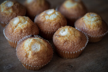 Close-up homemade muffins on wooden background.