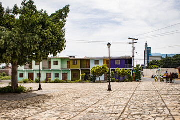 Fototapeta na wymiar Colorful Buildings with a Horse Drawn Carriage in Granada, Nicaragua 