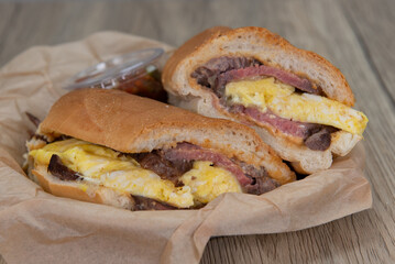 Breakfast steak and scrambled eggs sandwich loaded with protein and wrapped in an Italian roll