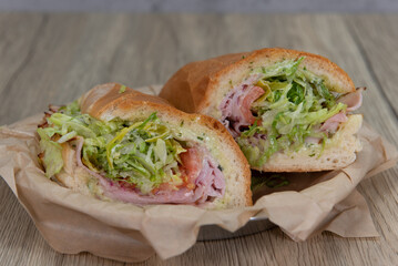 Loaded ham sandwich with provolone cheese, tomato, mayo, and red onion inside an Italian Roll for a...