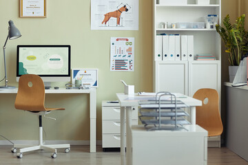 Background image of modern vet clinic interior, focus on workplace desk and certificates on wall,...