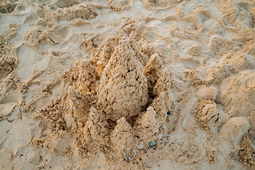 Sand castle view from above, fine river sand for hand games, city beach, sea coast.