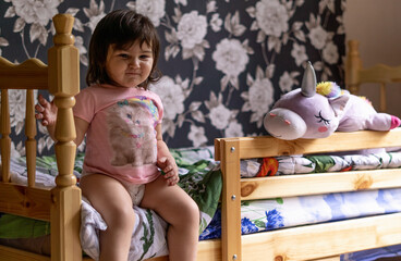 little girl in her room playing with her toys and stuffed animals