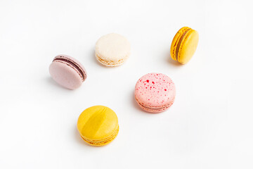 Macaroons sweet food on white background. Pastel yellow, pink color background. 