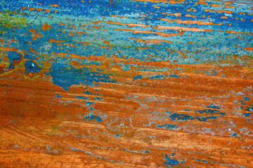 Old scraped cracked paint blue and red on the board