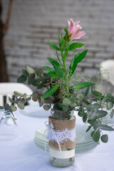 flowers in a vase in a wedding table