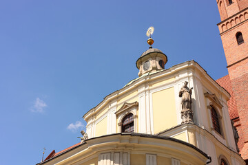 Facade of old building with sculptures against blue sky, low angle view