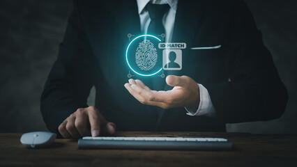 Businessman wearing suit with keyboard and mouse, hologram icon fingerprint encryption, protecting access to confidential information by using fingerprint technology. Fingerprint encryption concept.