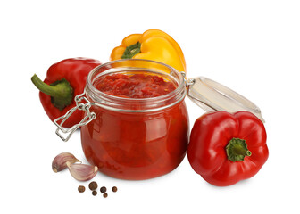 Glass jar of delicious canned lecho, fresh vegetables and peppercorns on white background