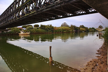Lido di Dante, Ravenna, Emilia Romagna, Italy: the old Bailey bridge built during the second world war crossing the river near the Adriatic sea beach
