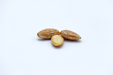 peeled almonds on white background