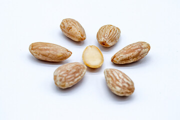 peeled almonds on white background