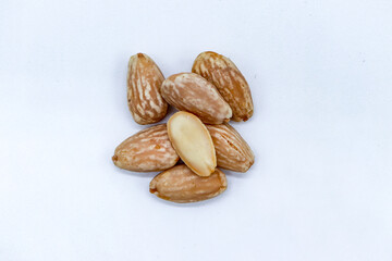 peeled almonds on white background