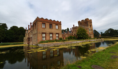 Obraz premium Oxburgh Hall with moat and reflections