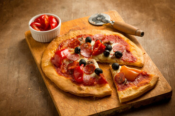 sliced pizza with pepper and hot sausage
