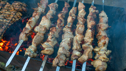 Selective focus. Cooking barbecue on the mangal in nature. Grilled tasty meet cooking on the party