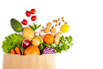 Healthy food background. Healthy vegetarian vegan food in paper bag vegetables and fruits on white, copy space, banner. Shopping food supermarket and clean vegan eating concept.