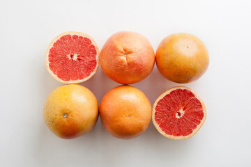 A Row of Grapefruits on White Background