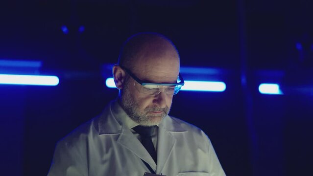 Professional tester testing , burning piece of fireproof building material  by gas torch inside  futuristic laboratory.  Construction engineer doing experiment . Physicist working in lab . Slow motion