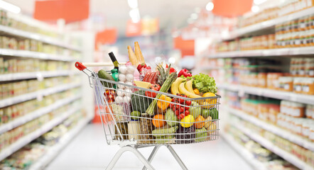 Full shopping cart with groceries in a supermarket