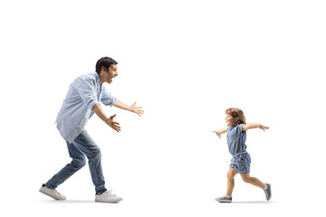 Father and little girl running towards each other to hug