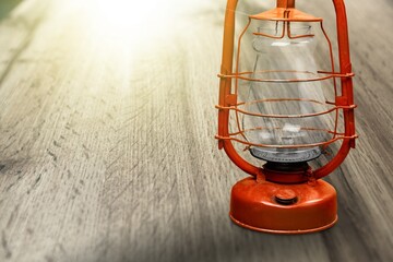 old kerosene lantern, antique vintage lamp on wooden table