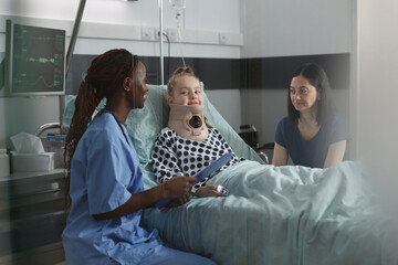 Unwell suffering kid recovering in pediatric hospital ward while resting in patient bed. Nurse...