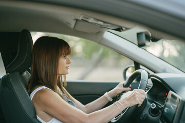 Obraz na płótnie Canvas side view of the interior of a car with a female driver