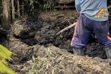 men working in landslide and mud