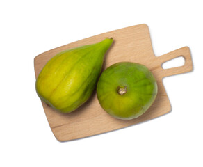 Green fresh figs on a white background. Fig fruit on a cutting board.   The fruit of a subtropical deciduous plant of the Mulberry family.