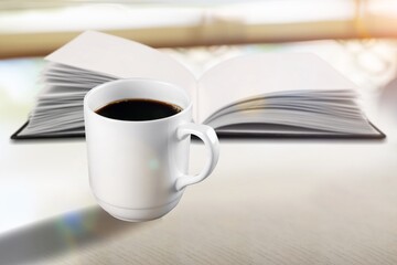 Reading book at home with a cup of coffee. Relaxation mood, cultural activity. Freedom, information, knowledge concept.