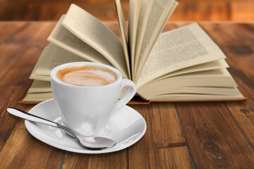 Reading book at home with a cup of coffee. Relaxation mood, cultural activity. Freedom, information, knowledge concept.