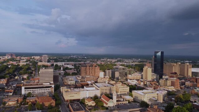 Drone footage of financial and administrative offices in downtown district of Lexington, Kentucky with campus and buildings of University of Kentucky visible on the distance