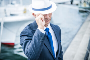 日本人　ビジネス　港　漁港　仕入れ　海　スーツ姿の中年男性