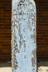 vintage shabby wooden post with old cracked paint