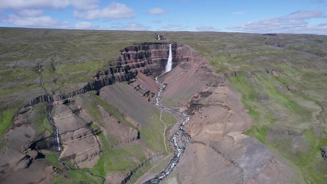 Hengifoss waterfall and surrounded by layers of basaltic strata and river flowing in Fljótsdalshreppur at East Iceland
