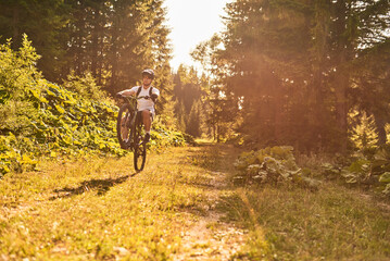 A cyclist rides a bike on extreme and dangerous forest roads. Selective focus